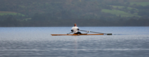 A man kayaking on a lake.